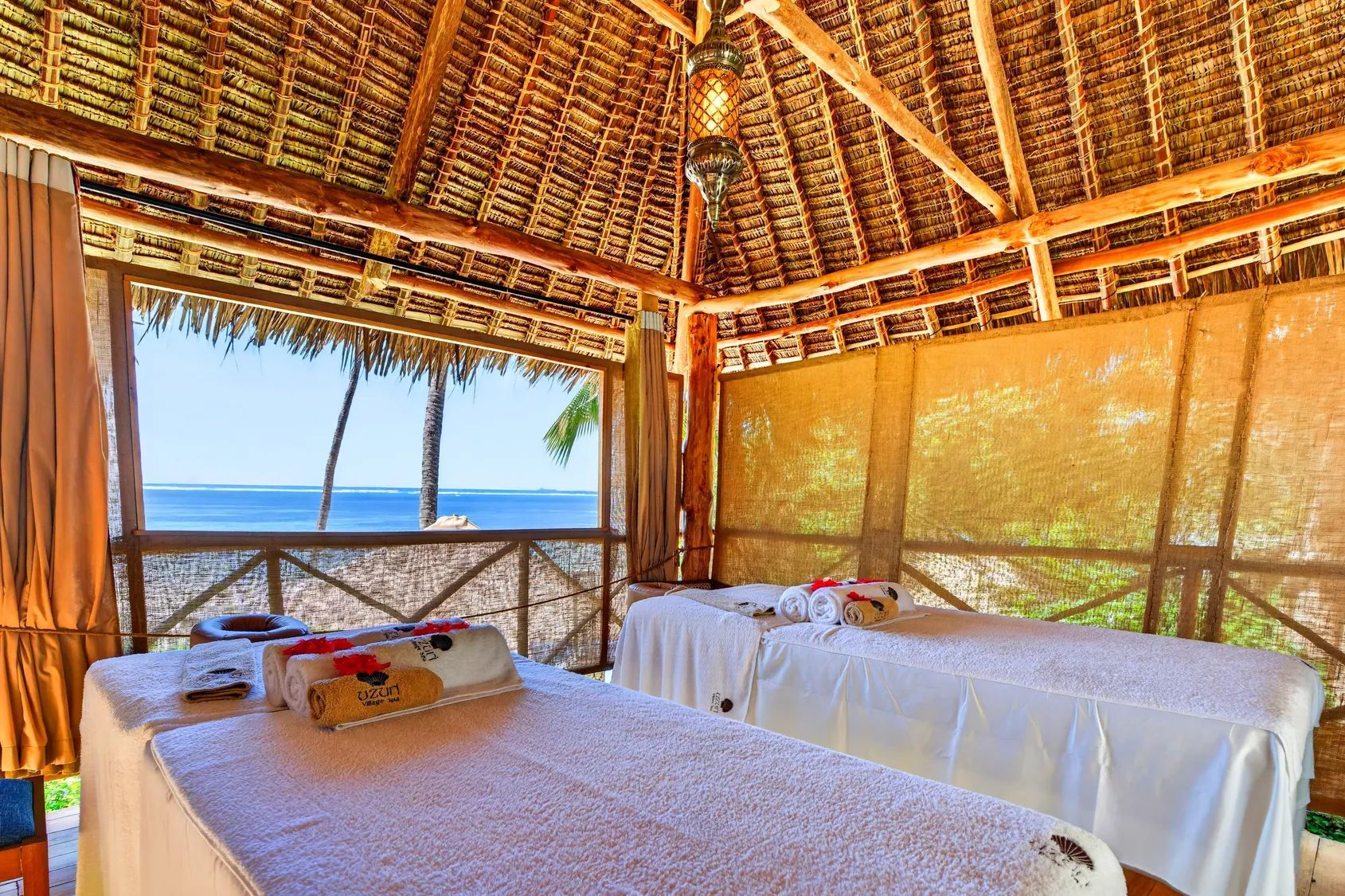 A thatched spa banda open to the Indian Ocean